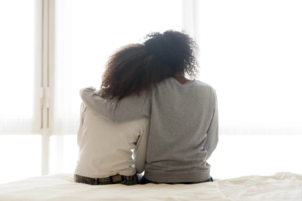 Mother hugging teen