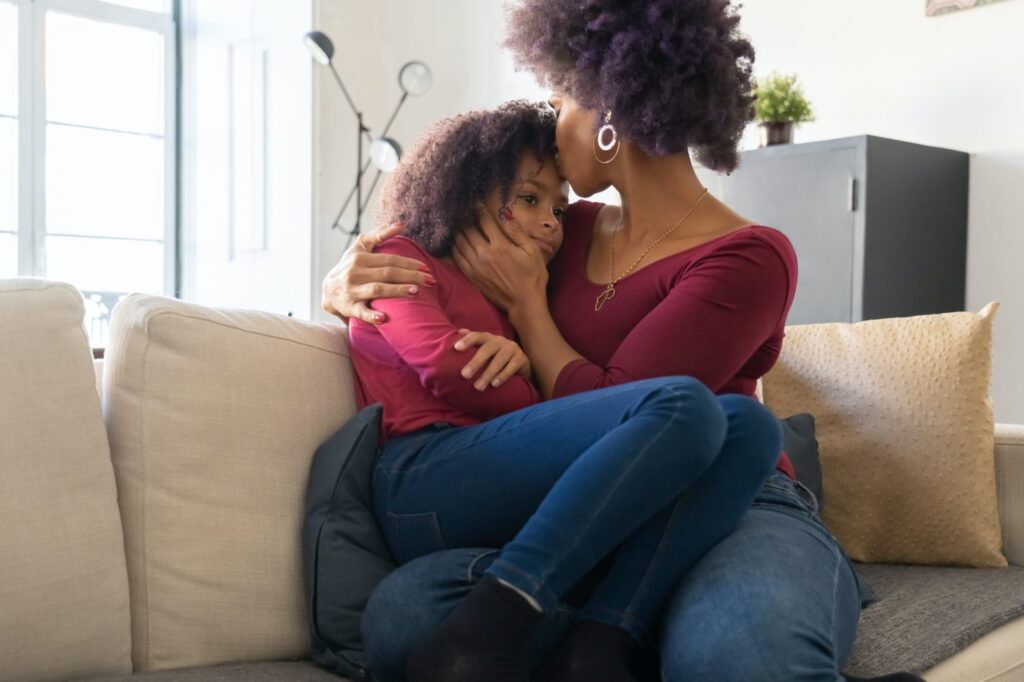 Woman and child sitting together on couch
