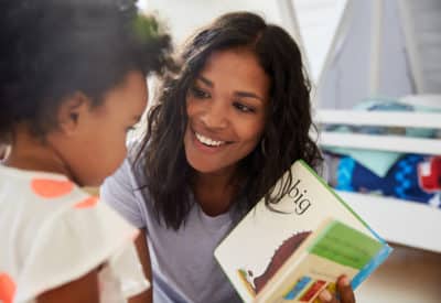 Woman smiling at child